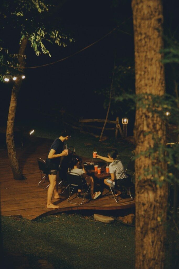 Friends gathered around a table at night